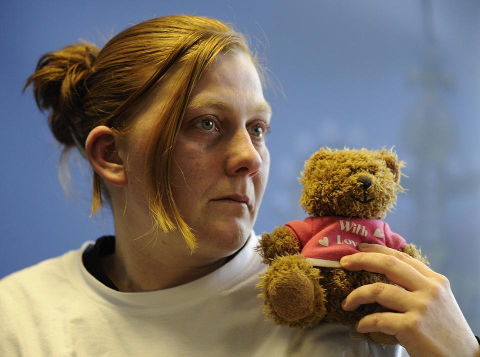 Karen, the mother of Shannon Matthews, pictured holding her daughter's favourite teddy bear as she made an emotional appeal for her safe return