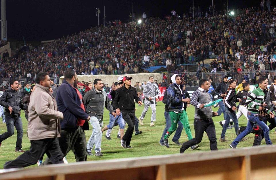  Fans rush onto the field following Al-Ahly's match against Al-Masry