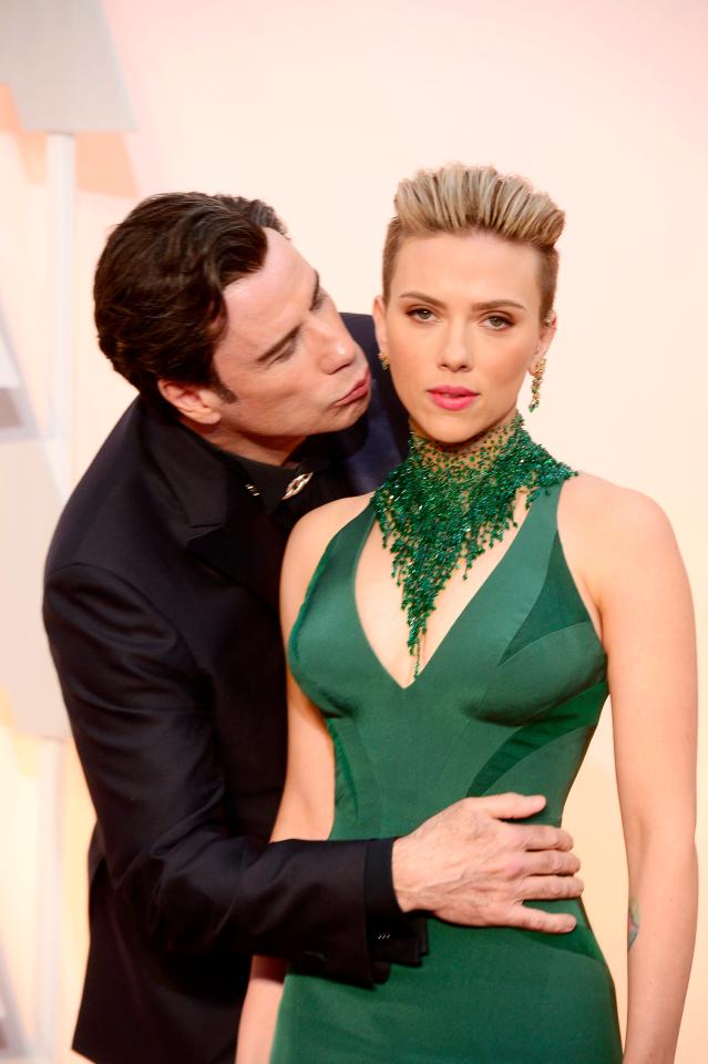  One of the most awkward photos ever, John Travolta jokingly kisses Scarlett Johansson