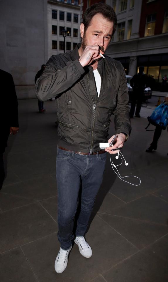  Hard partying star puffs away on a fag outside Radio 1 in London