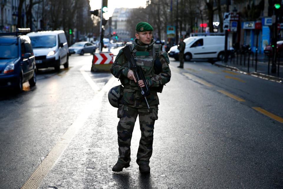  A military officer stands guard after a man carrying a knife attempted to enter a Paris police station