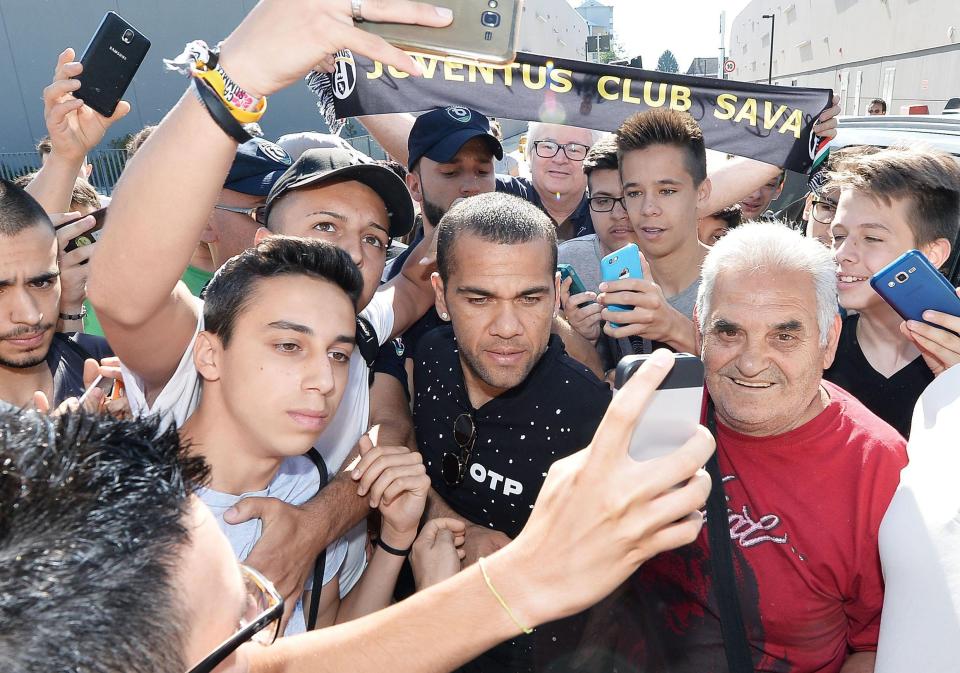 Dani Alves is mobbed by fans as he arrives in Turin ahead of Juventus move