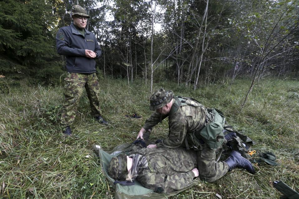  A member of the EDL practices first aid during forest warfare training