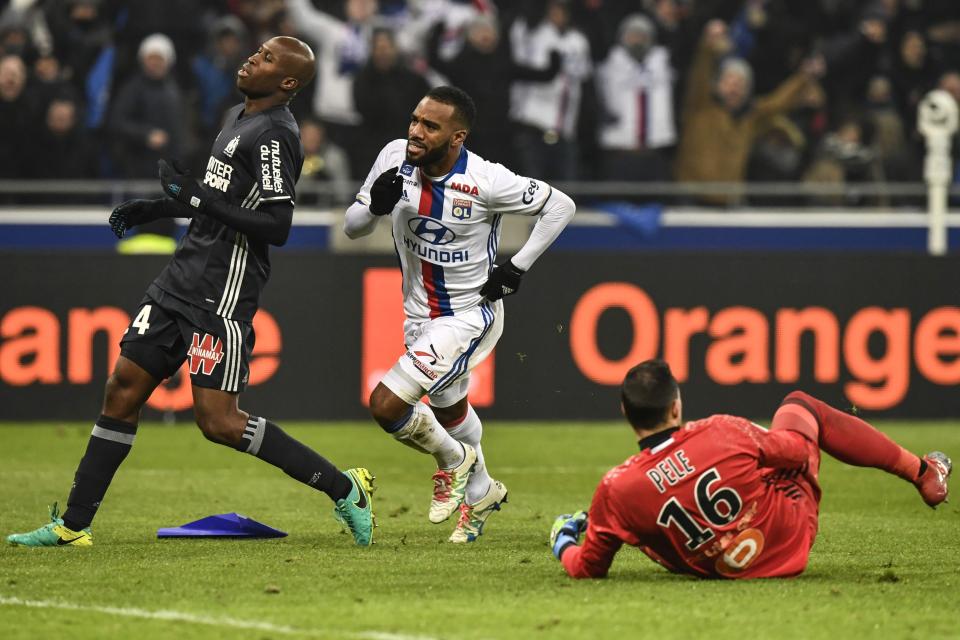 Alexandre Lacazette wheels away after scoring against Marseille