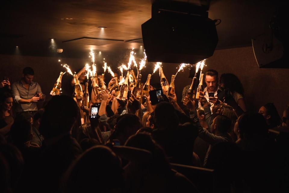  Staff walked through the club holding bottles of Champagne and sparklers