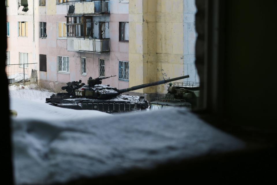  A tank rolls through Avdiivka as the two sides exchange mortar and rocket fire for a fourth day