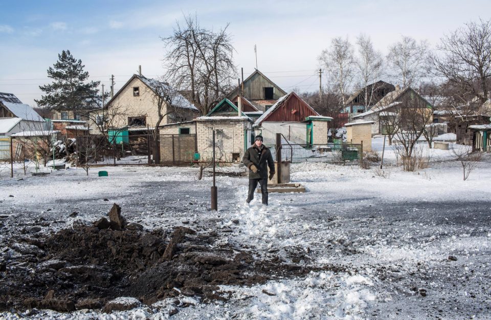  A resident, who did not want to provide his name, shows where one of six grad rockets landed in his back yard at around 7:30am in Avdiivka