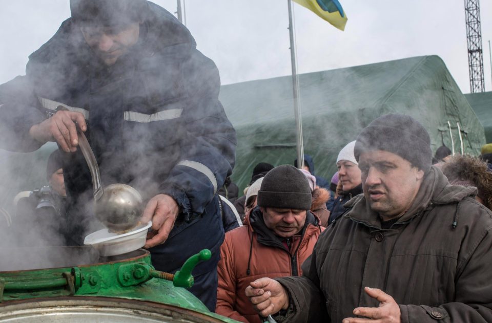  Residents are provided with hot soup by the emergencies ministry at a humanitarian assistance point