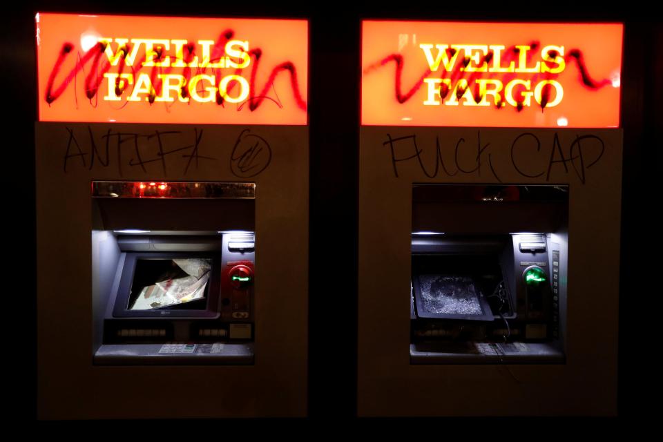  Vandalised cash machines are seen at a Wells Fargo bank