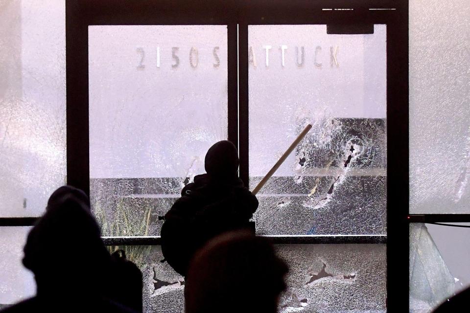  A protester smashes a bank window during the violence