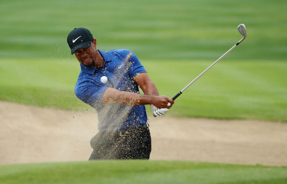  Tiger Woods plays from a bunker during his round on Thursday in Dubai