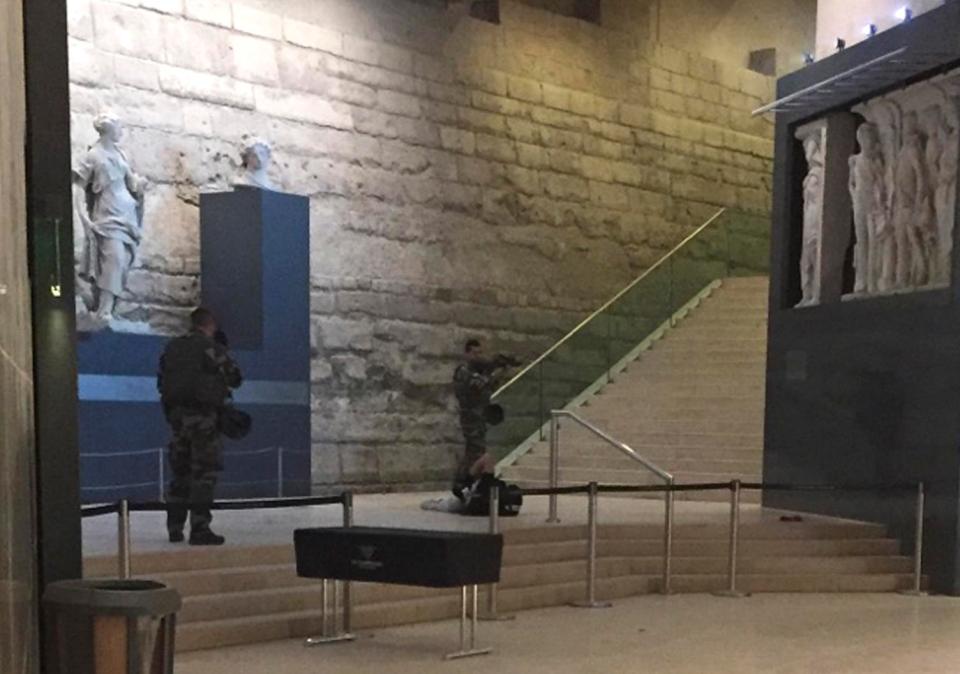  The terror suspect is pictured lying on the floor, guarded by soldiers