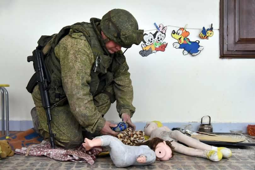  A soldier disarms a booby-trapped doll found in a wrecked school in eastern Aleppo