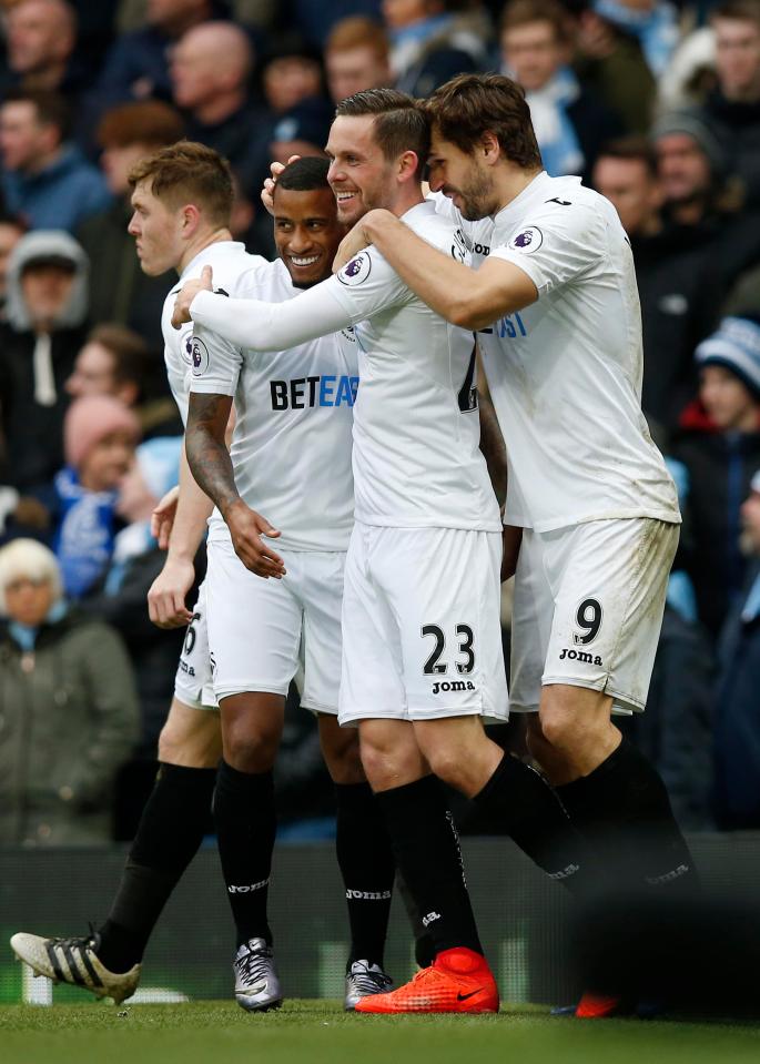 Swansea celebrate Gylfi Sigurdsson's late equaliser at the Etihad Stadium