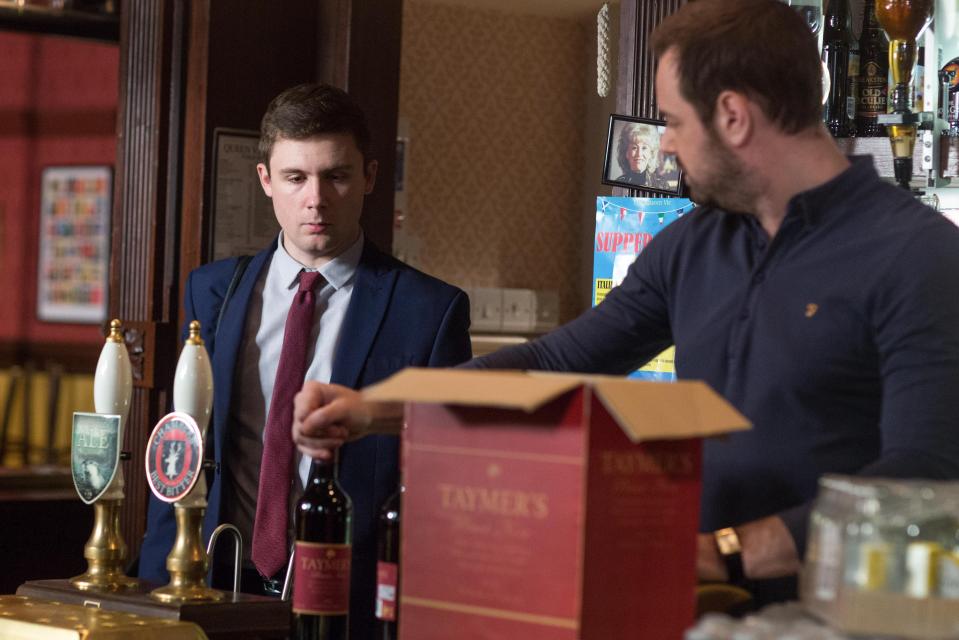  Lee gazes sadly at the box of wine behind the bar