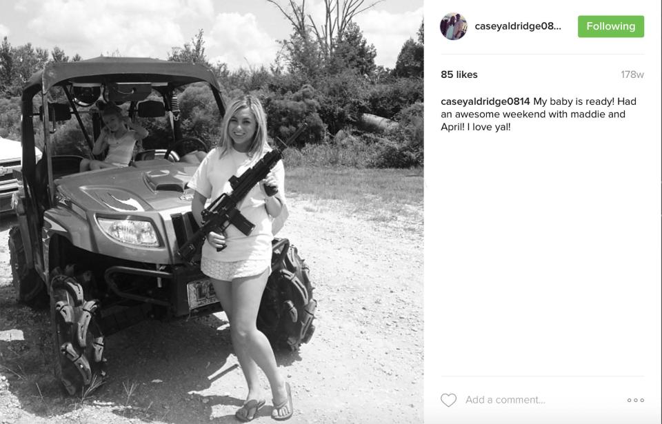  The youngster is pictured in 2013 in an ATV alongside a woman brandishing a gun