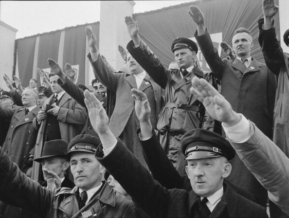  1938: Members of the Nazi-oriented Sudeten German Party salute during a rally, Czechoslovakia