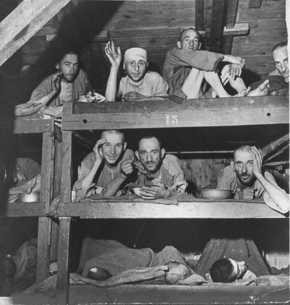  1945: Half-starved inmates at Buchenwald lying in their bunks, during liberation by American forces