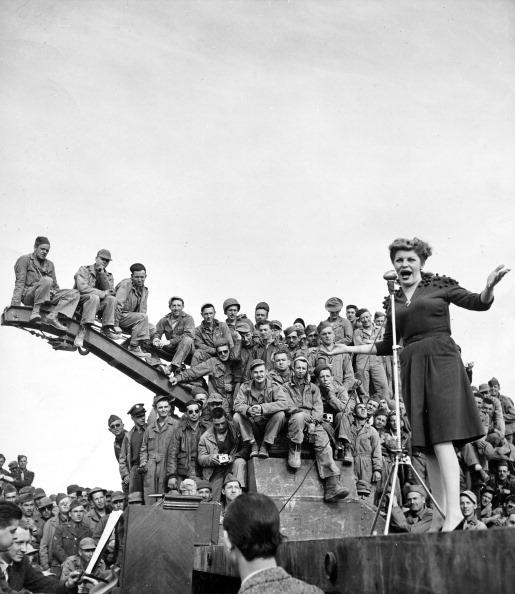  1943: American singer Martha Raye performs for an audience of American soldiers during a USO tour for troops still stationed in postwar North Africa