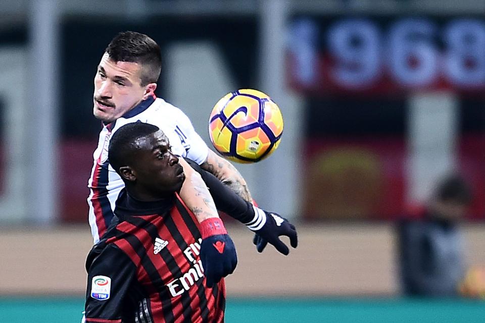 M'Baye Niang challenges Cagliari defender, Fabio Pisacane for the ball in air