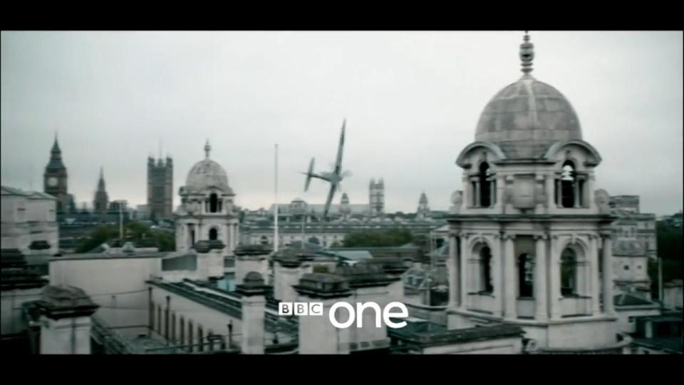 A fighter plane swoops over the streets of London