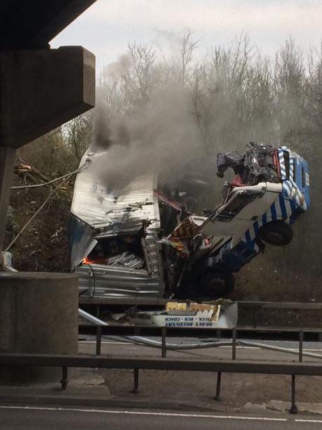  A lorry has plunged 30ft from a bridge and onto a busy carriageway in Essex