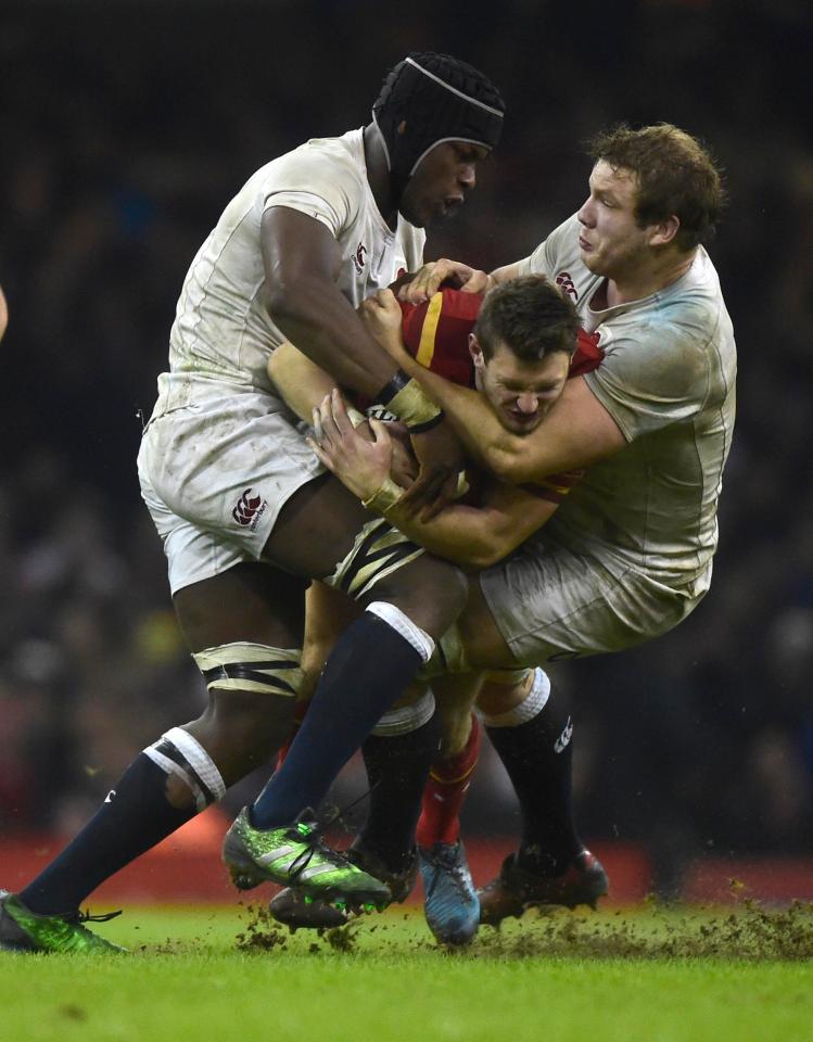 Brave Wales fly-half Dan Biggar is tackled by Maro Itoje and Joe Launchbury