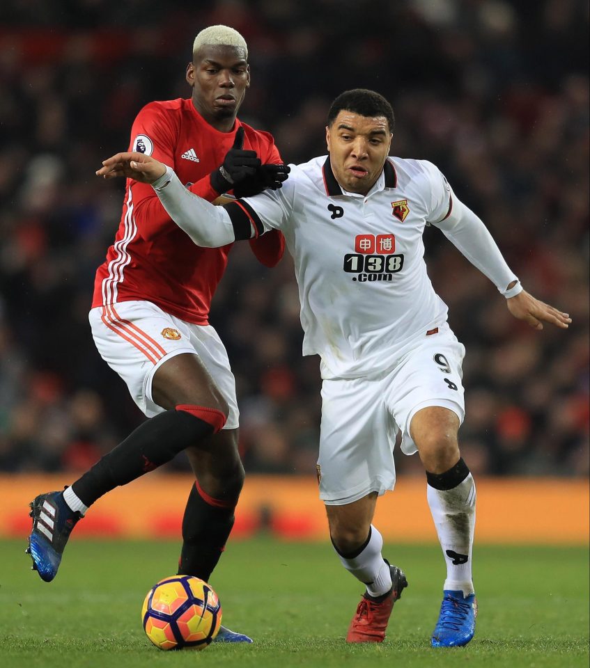  Troy Deeney pictured playing for Watford against Manchester United's Paul Pogba