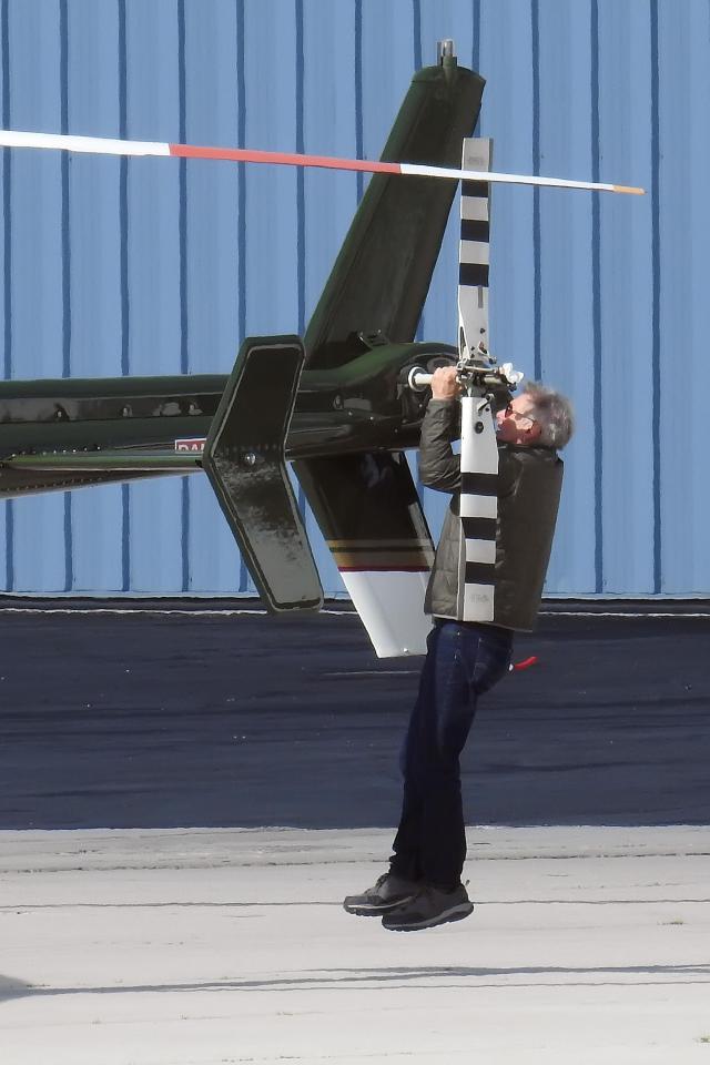  Harrison Ford hangs from the propeller of his aircraft at  Santa Monica airport