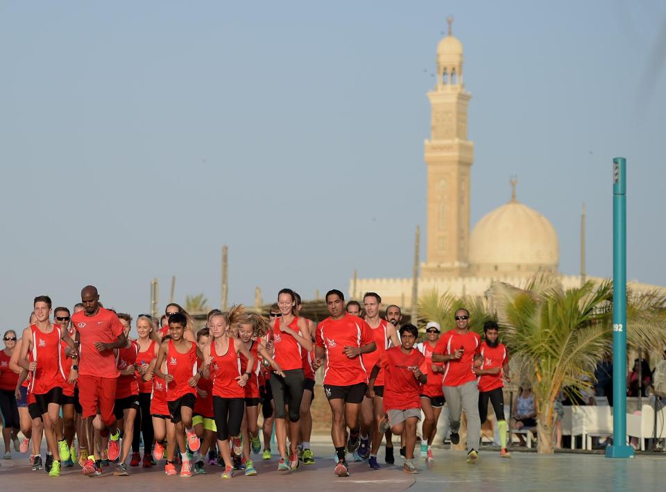 Mo Farah runs with a group of local joggers in Dubai as he forms part of a recording for a 360-degree tourism video