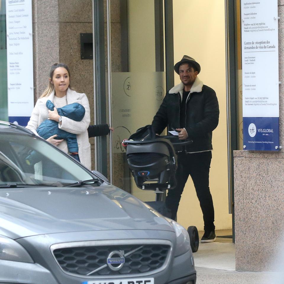 Earlier they were seen leaving the Canadian visa offices as Emily clutched Theo in her arms