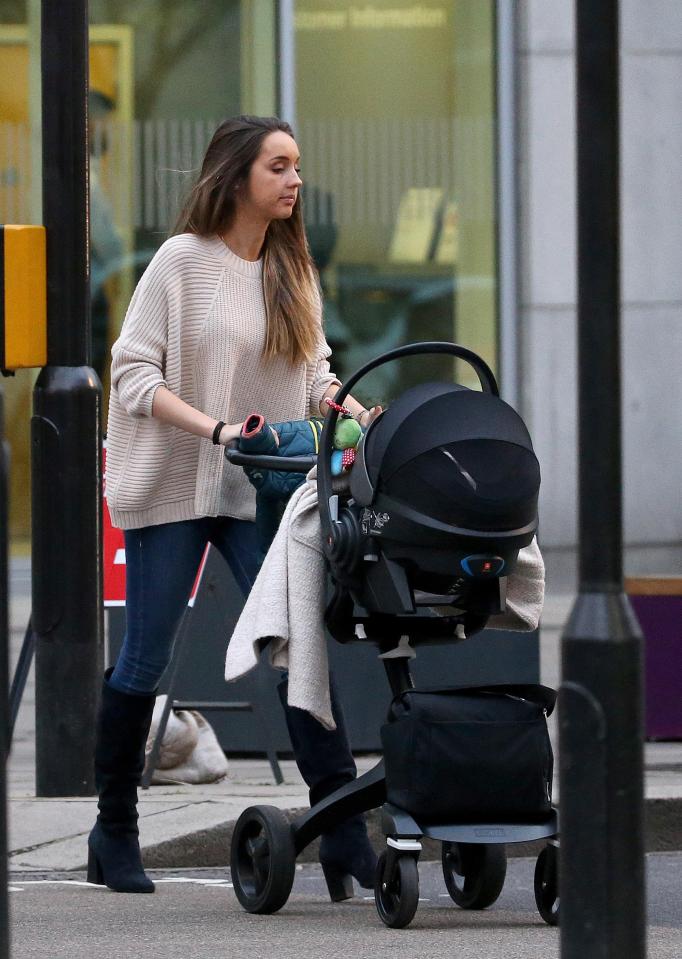 Emily went coat-free as she pushed her little tot in his pram