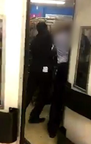  The man is seen being detained by the staff members after being dragged from the shop floor