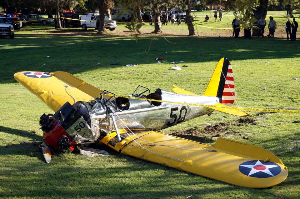  A World War II-era trainer airplane rests on the ground after actor Harrison Ford crash-landed it in 2015