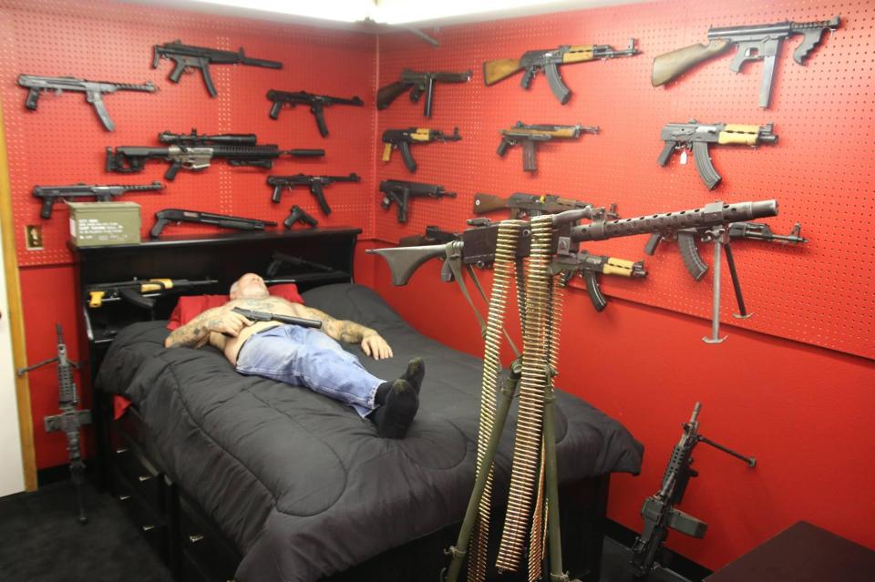  He even sleeps surrounded by machine guns mounted on his bedroom wall