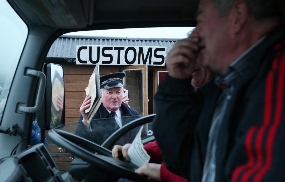  Seamus McDonnell dressed as old style customs officials stops a vehicle at the mock customs post in Ireland