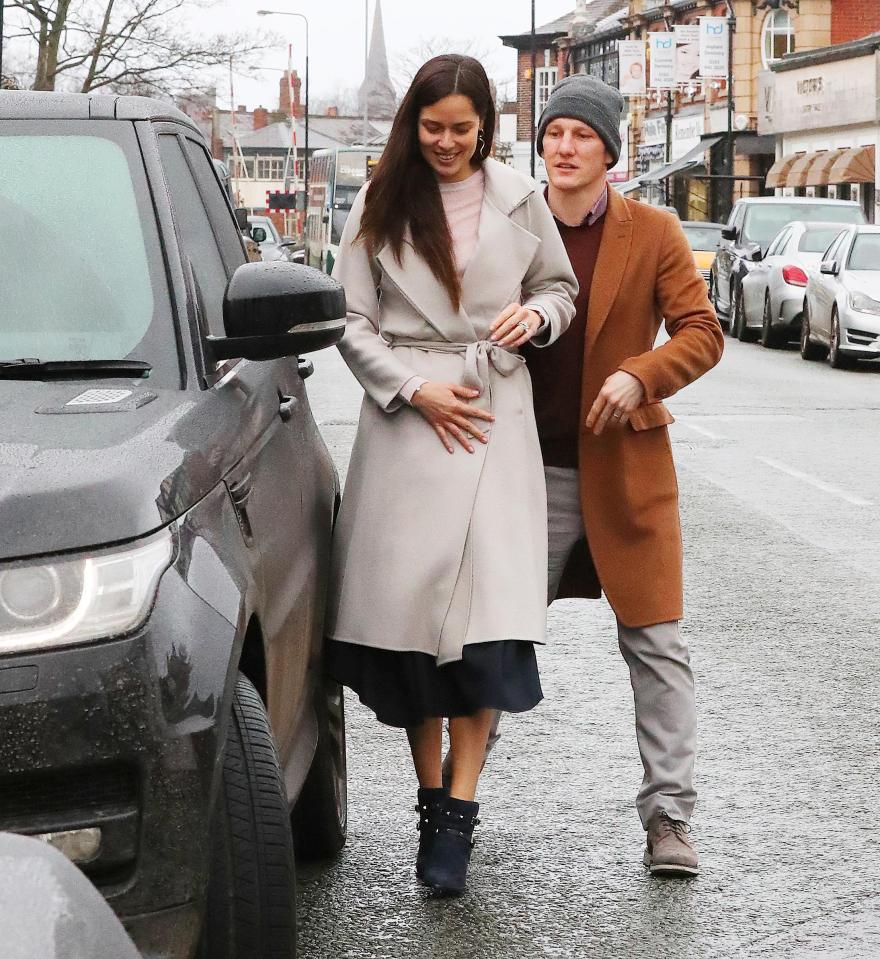  Ana Ivanovic was smiling as she held her stomach as Bastian Schweinsteiger opened the door for her