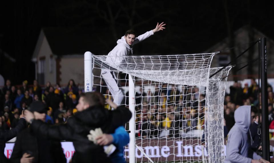 One fan tries to climb onto the crossbar at Gander Green Lane