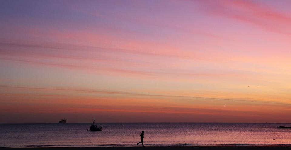  A jogger runs along Cullercoats beach in North Tyneside this morning before sunrise, as forecasters warn the conditions will be much more unsettled before the end of this week