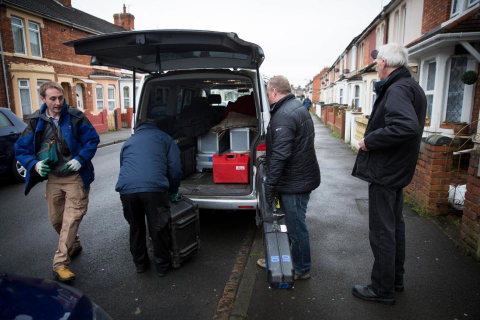 Officers from Wiltshire Police load items into a van outside the home of Christopher Halliwell