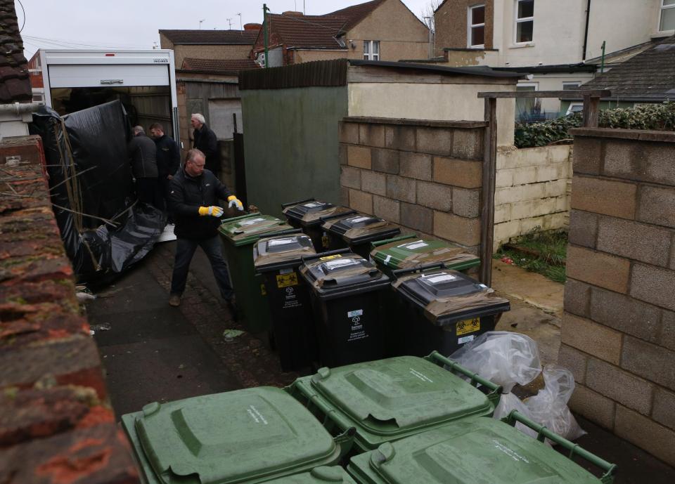 Police could be seen removing the Swindon council wheelie bins, which had been taped up and labelled with bright yellow warning stickers