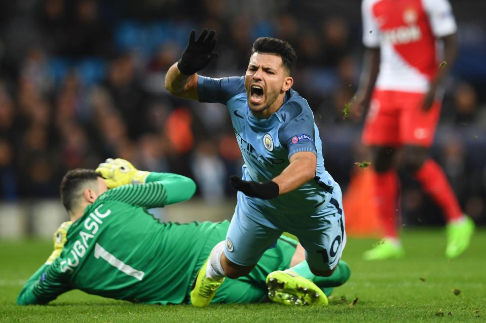 Aguero falls to the floor after a challenge from the Monaco goalkeeper