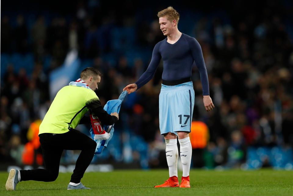 Kevin De Bruyne hands his shirt over to a 'steward' who turns out to be a fan