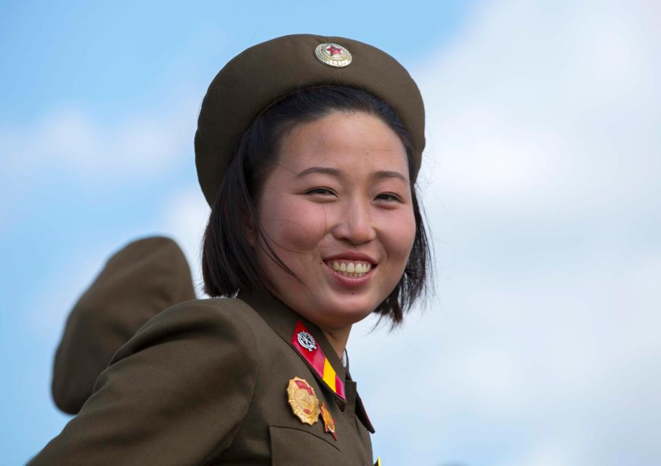  This young female soldier can clearly follow orders to smile