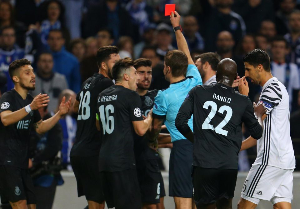  Referee Felix Brych shows a red card to Alex Telles