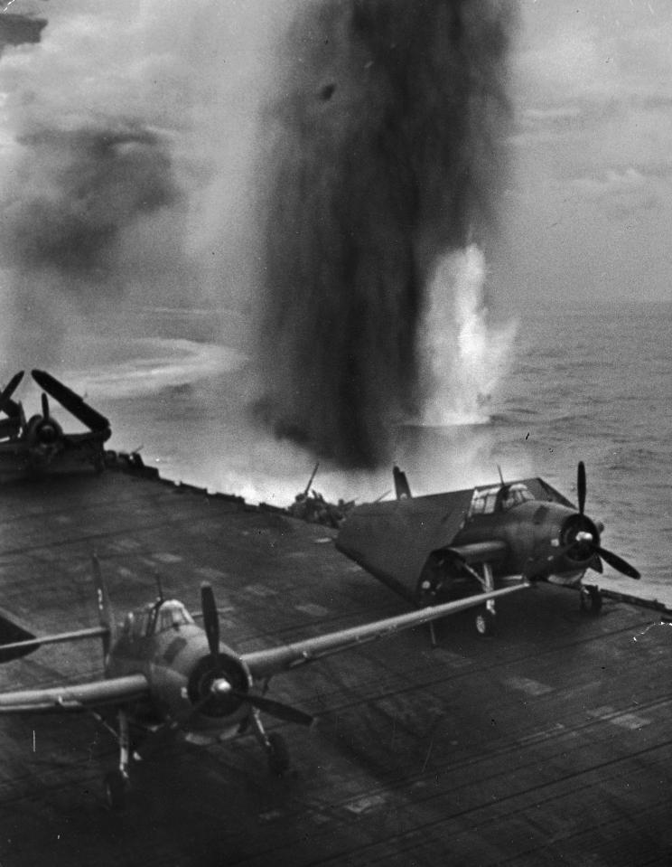  1944: A bomb explodes in the water off the port side of an American aircraft carrier during the battle for Saipan