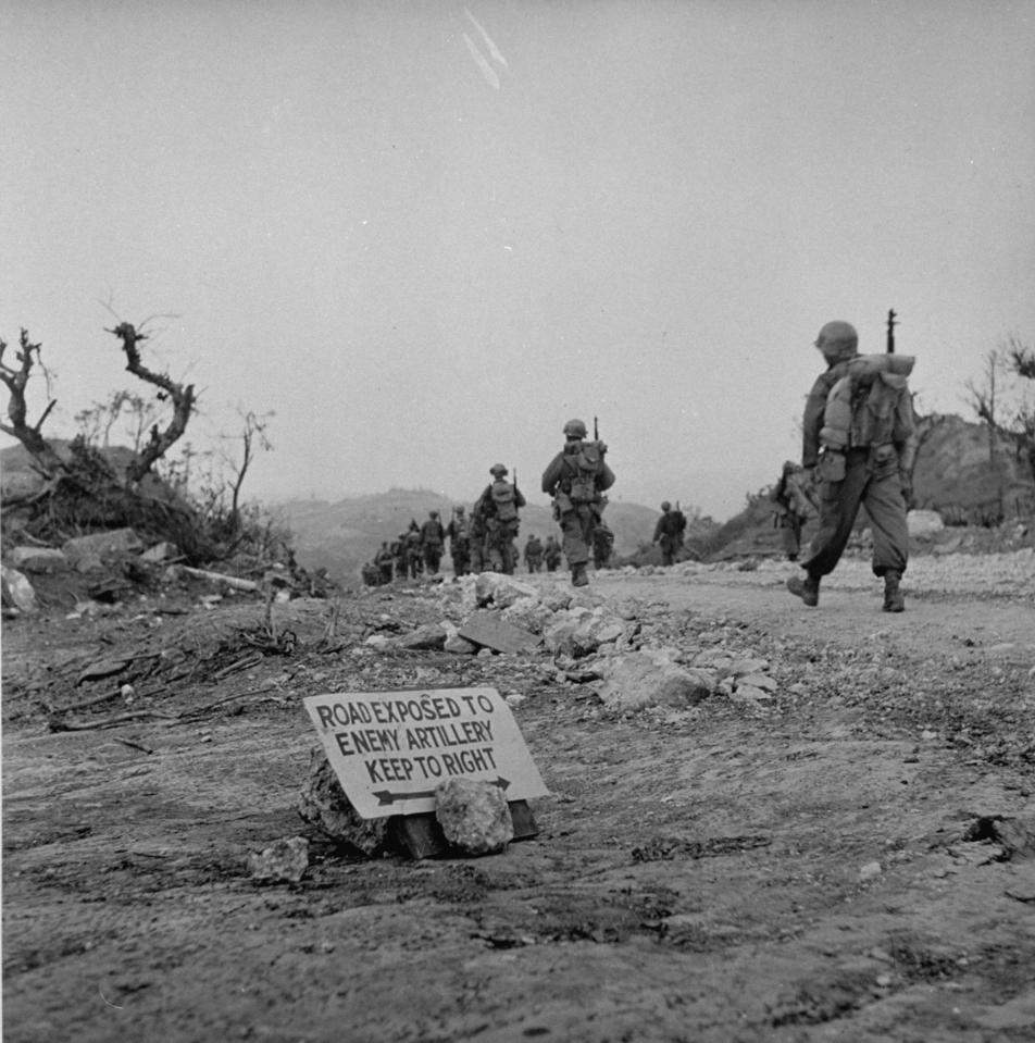  1945: Soldiers march towards the front line as they prepare to for battle in Okinawa