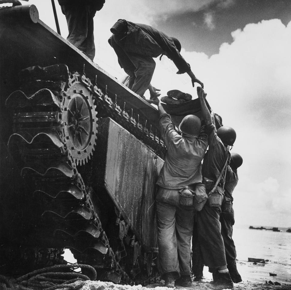  Wounded American Marine being loaded onto an 'alligator' tracked amphibious vehicle for evacuation during fighting against Japanese for Asan Point