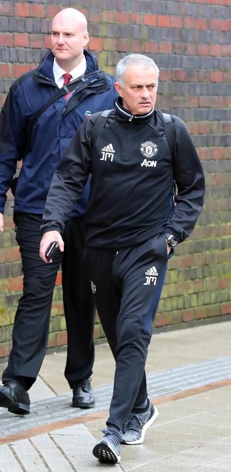 Manager Jose Mourinho was seen clutching his mobile phone at the station