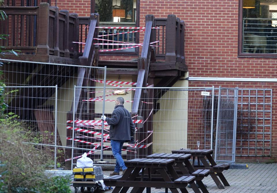  A worker cordons off the area where the collapse took place